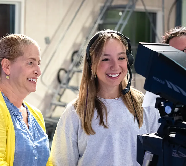 A Marietta College student majoring in journalism and broadcasting runs a camera during class