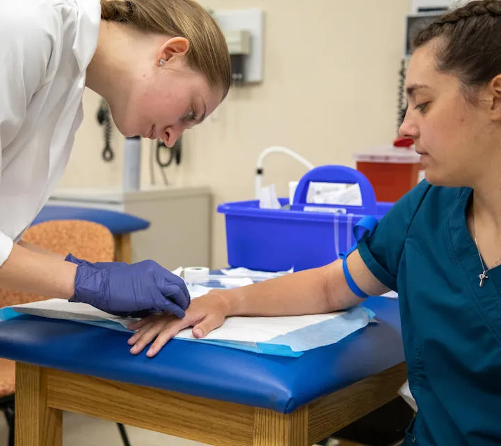 A Marietta College Physician Assistant Studies graduate student draws blood.