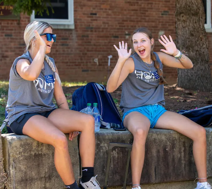 Two Marietta College HOME Onboarding Leaders take a break from moving in first year students