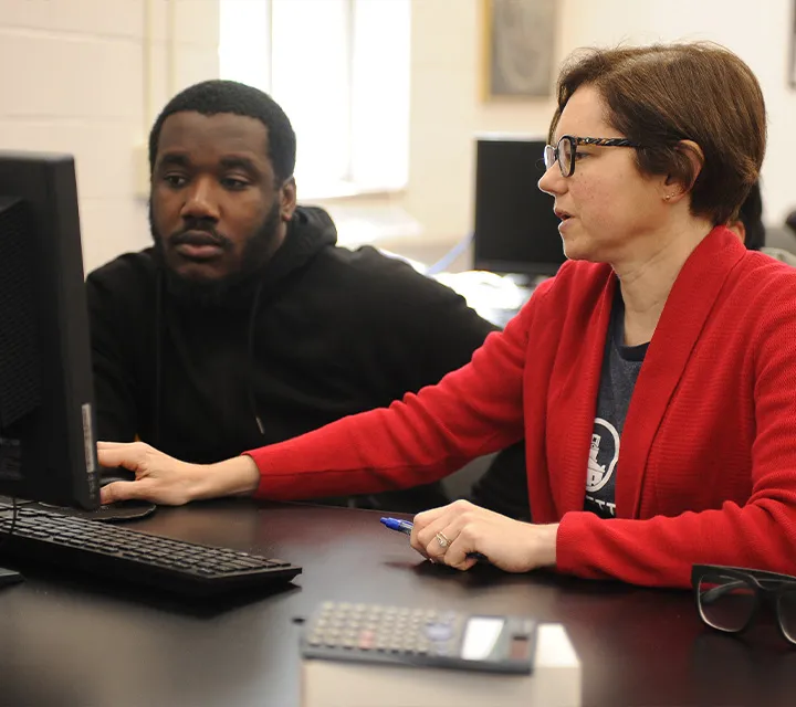 Dr. Ann Bragg works one-on-one with a student.