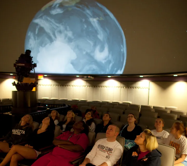Students enjoy a show in the Anderson Hancock Planetarium. 