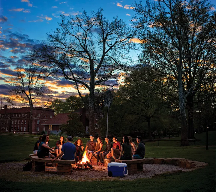 Marietta College students sit around a campfire