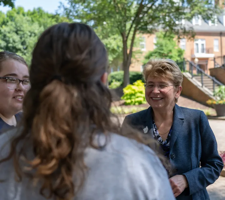 Dr. Drugovich with Marietta College students on the Christy Mall