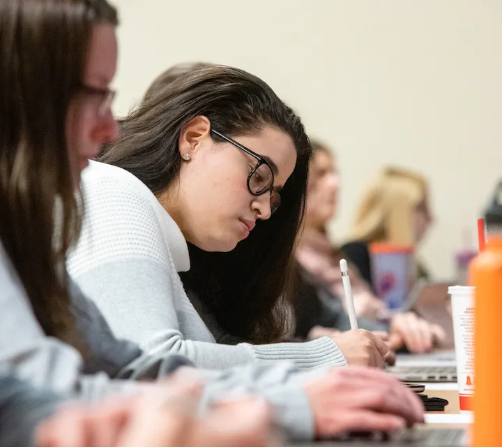 A Marietta College student writing during class