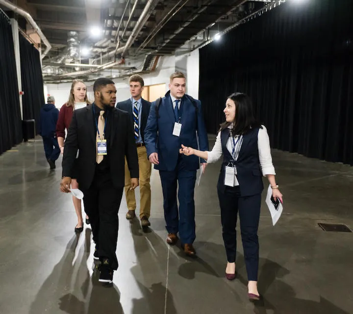 Marietta College Sport Management majors walking and talking with a Columbus Blue Jackets Employee