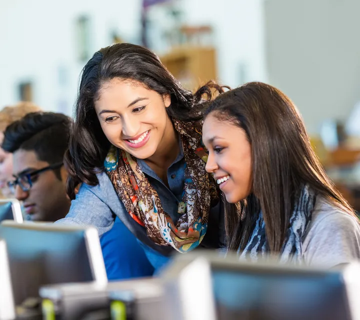 A teacher speaks to a student