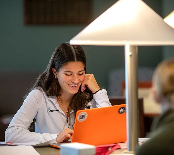 A Marietta College student uses a laptop while studying in Legacy Library