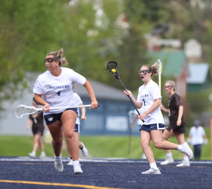 Two Marietta College women's lacrosse players during a game