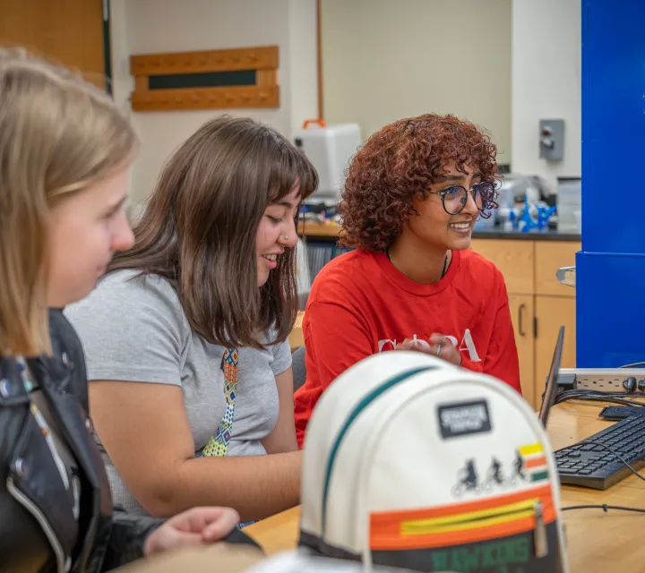 Three female students in a computer lab