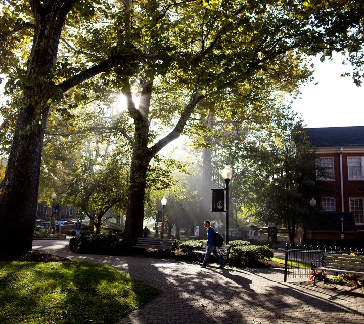 Student walks past Andrews Hall on to the Mall