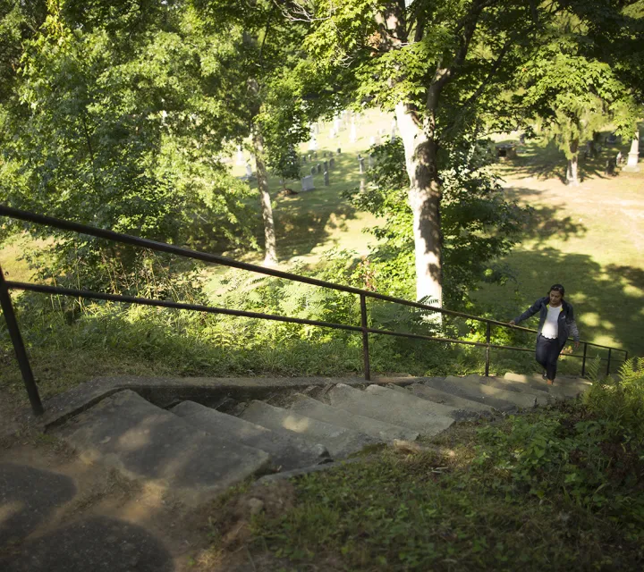 Student walking up the Mound in Mound Cemetary