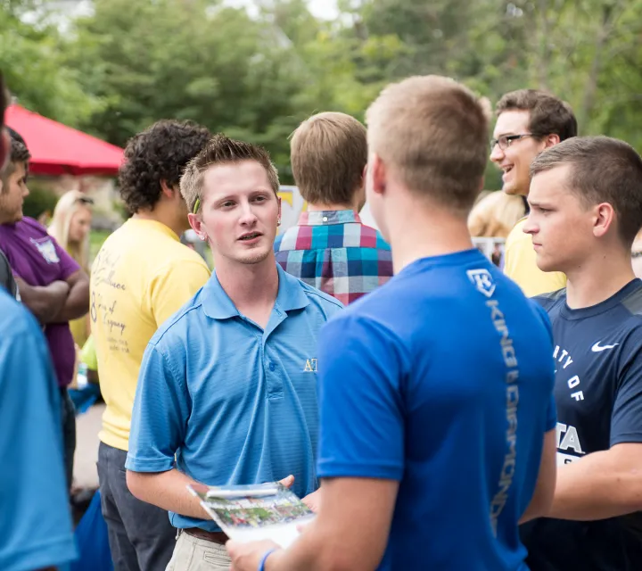 Fraternity members talk to potential new members at the Involvement Fair