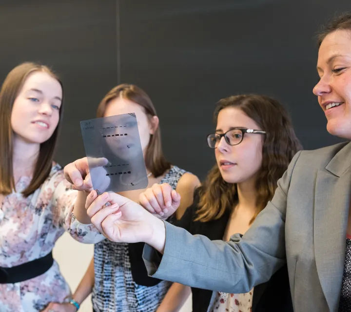 students and professor look at data from DNA