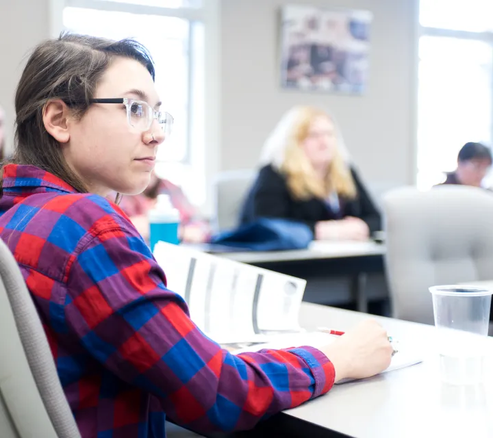 student listening to presenter during the Leadership Conference