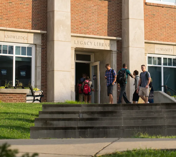 Students walk outside of the Legacy Library