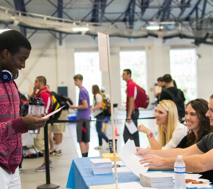 Student filling out a form at Enrollment Day