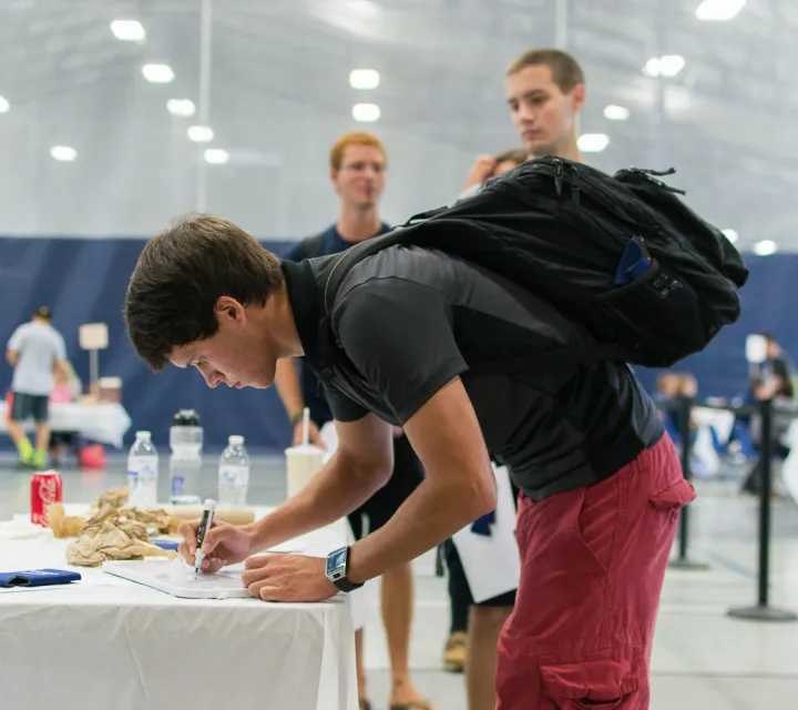Student signs papers in the DBRC