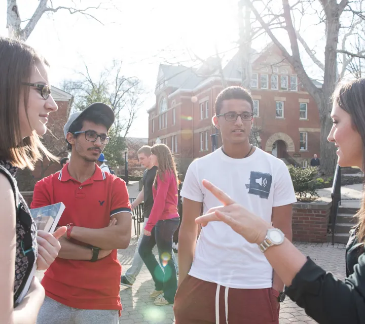 Students talk outside of Gilman