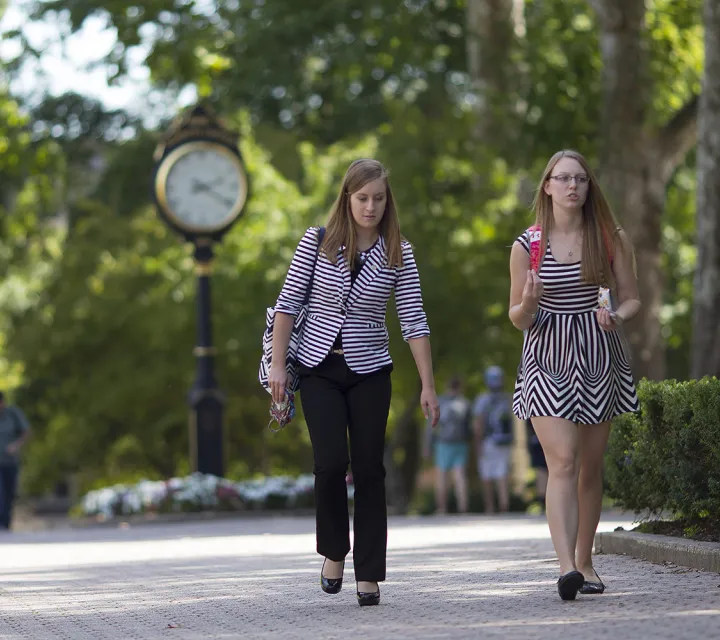 Two students chat on the Mall