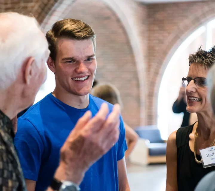 A Marietta College student and parent meet with members of the MOV