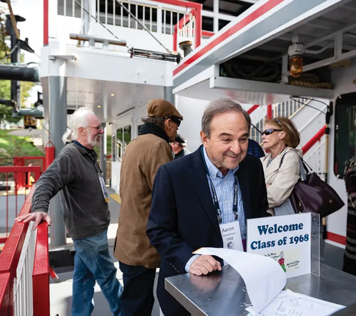 A member of the Marietta College class of 1968 checks in for the lunch boat cruise