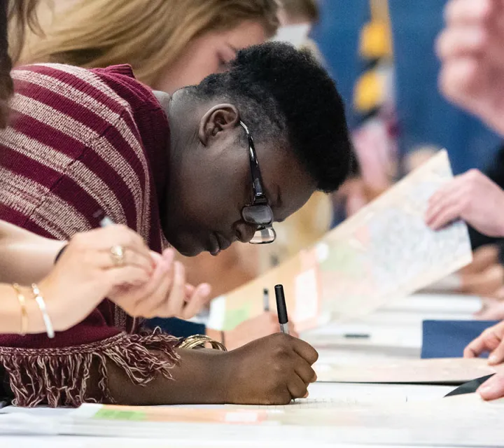 A Marietta College class of 2023 student signs the rolls at matriculation