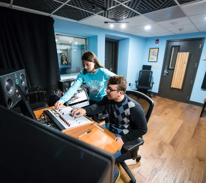 Two Marietta College students work in the recording studio
