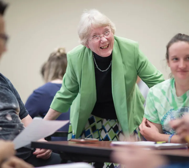 A Marietta College Education professor speaks with her students