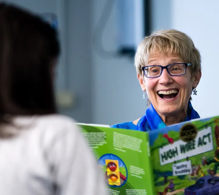 Kathy Brodsky '67 smiles over one of her children's books