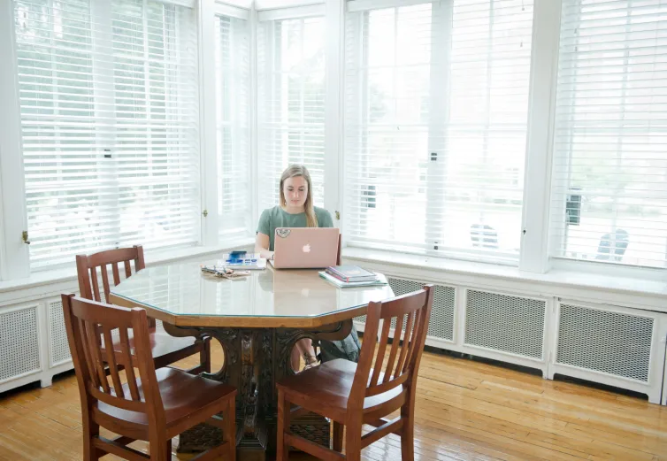 Female student studying at table