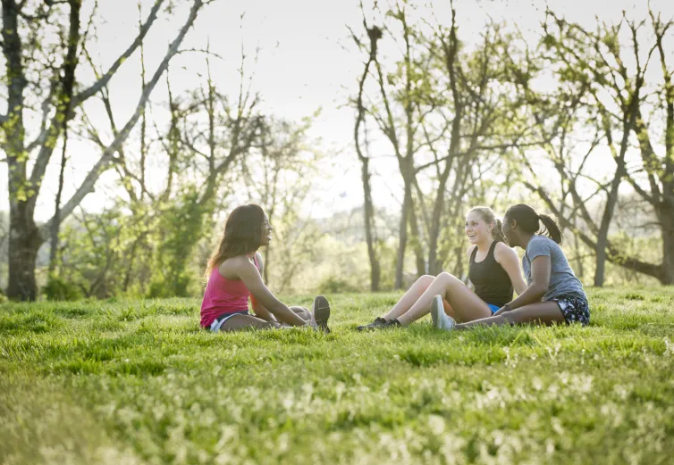 Three Marietta College students stretch outside