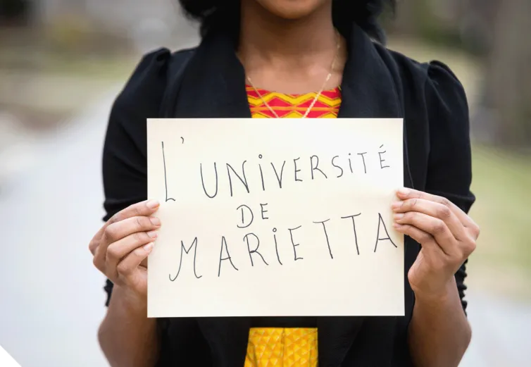 A Marietta College student holding a sign