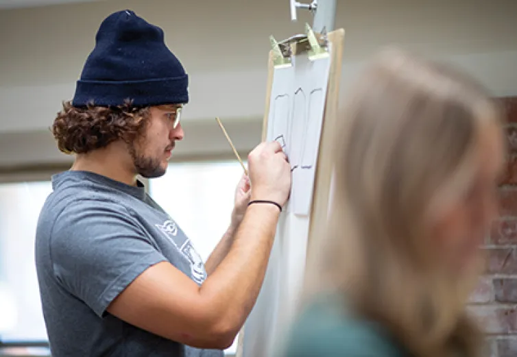 Petroleum Engineering student Derek Witsberger ’24 works on his artistic skills in instructor Liz Davenport’s Drawing I class.