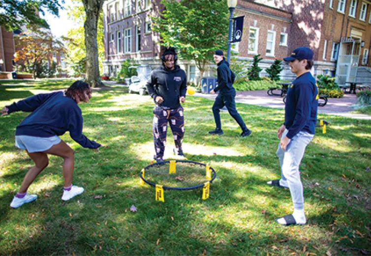 Alayna Francis ’26, left, Vanté Hodges ’26, middle, and Franko Rome ’26 play spikeball while Justin Shanklin ’26 runs behind them. Spikeball was just one of many activities students enjoyed as part of World Mental Health Day on campus.