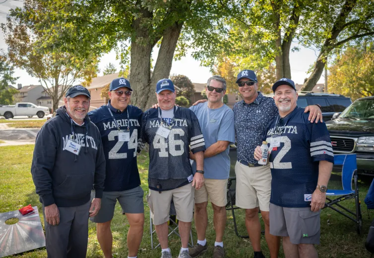 Six alumni tailgating during Homecoming 2025