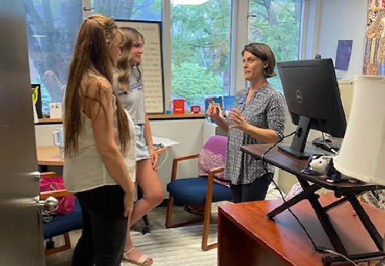 Two students meet with director in McKinney Media Center offices