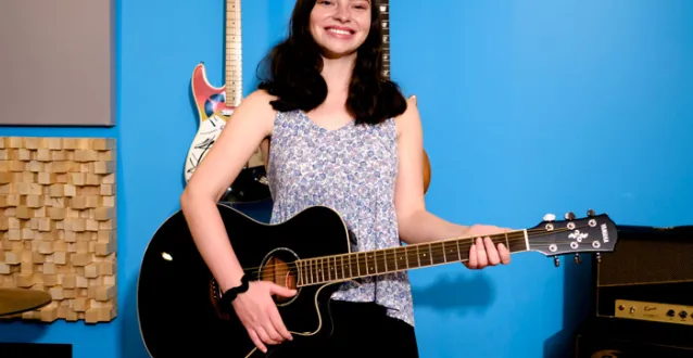 Lindsey McCoy playing a guitar