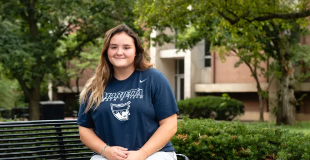 Savannah Flusche seated on a bench