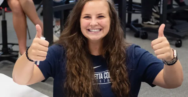 Female student giving thumbs up