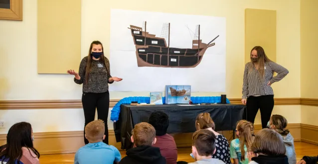 Education students speaking with fifth-graders