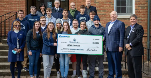 Students with faculty holding $1M check