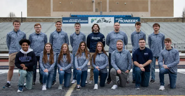 Students kneeling and standing