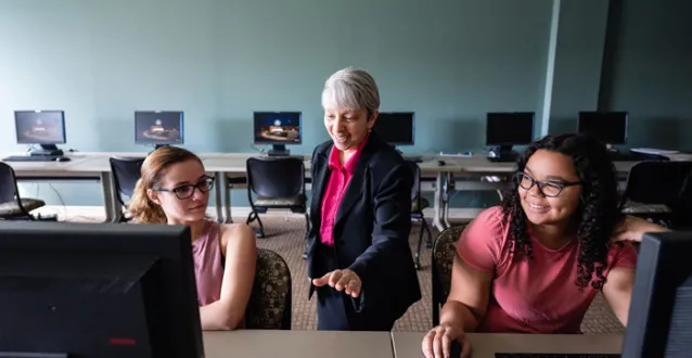 Grace Johnson working with students in a computer lab