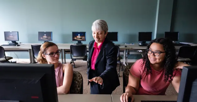 Grace Johnson speaking with two students