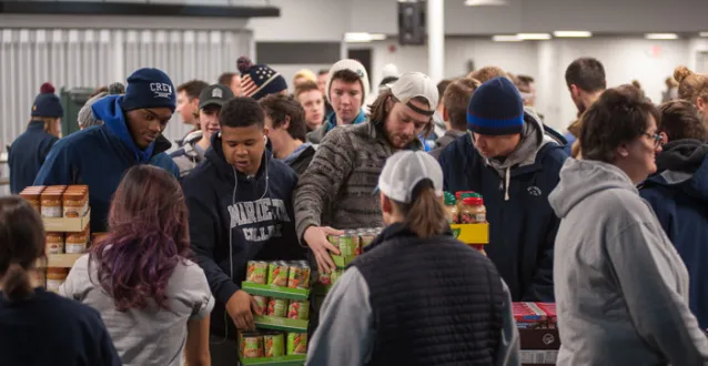 Students loading food into boxes