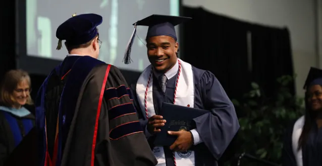 Male student receives diploma