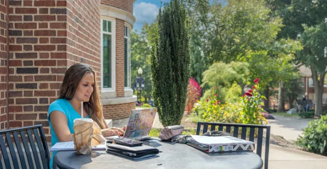 Female student studying outside