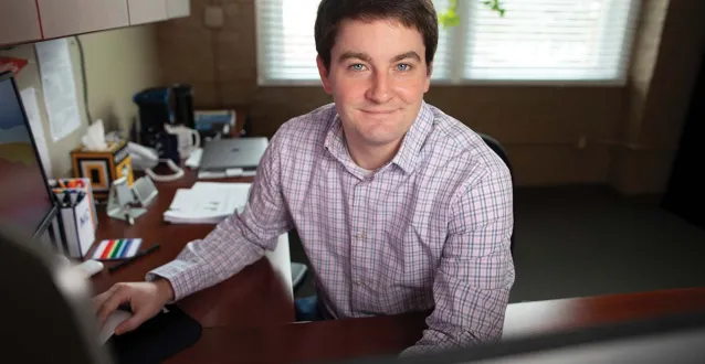 Charles Doan sitting at a desk