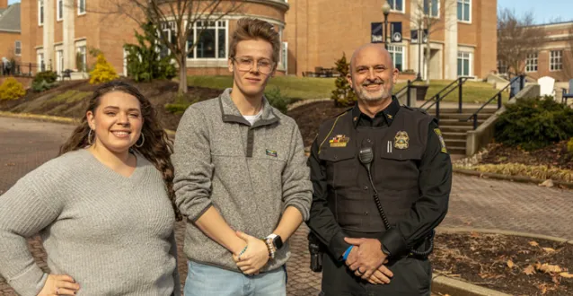 Jaden Koren, Colin Walters and Chief Jim Weaver pose for a photo on the Christy Mall