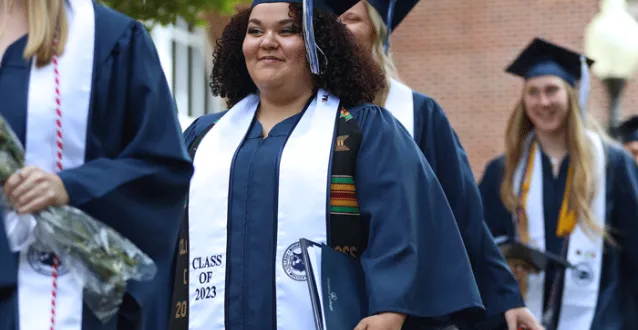 Graduate smiling following Commencement